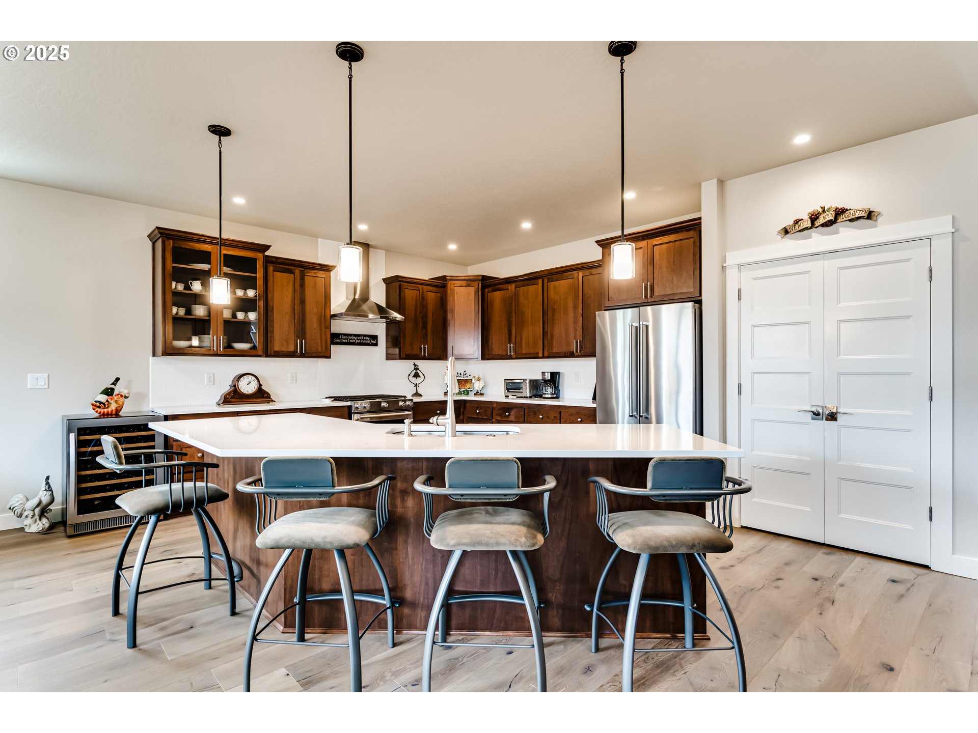 1489 Taylor Street Eugene, OR 97402 - Photo 13 of 47 a kitchen island with stainless steel appliances kitchen island granite countertop a dining table chairs sink and white cabinets