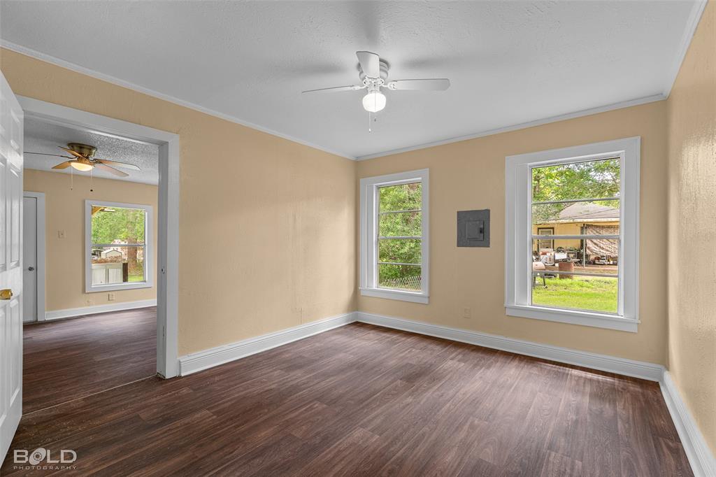 115 Pam Street Mansfield, LA 71052 - Photo 14 of 25 an empty room with wooden floor and windows