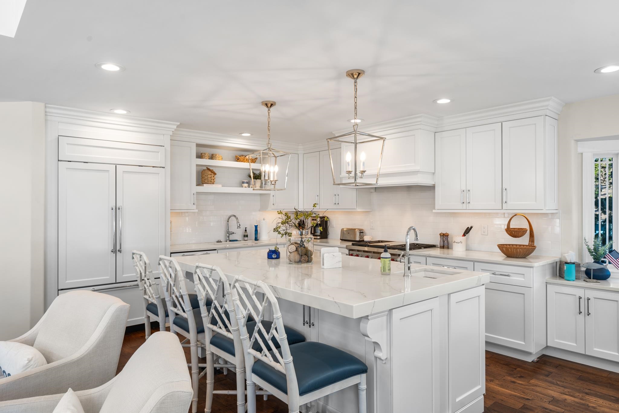 40 13th Street East Avalon, NJ 08202 - Photo 16 of 40 a kitchen with stainless steel appliances kitchen island granite countertop a sink a stove a refrigerator and white cabinets with wooden floor