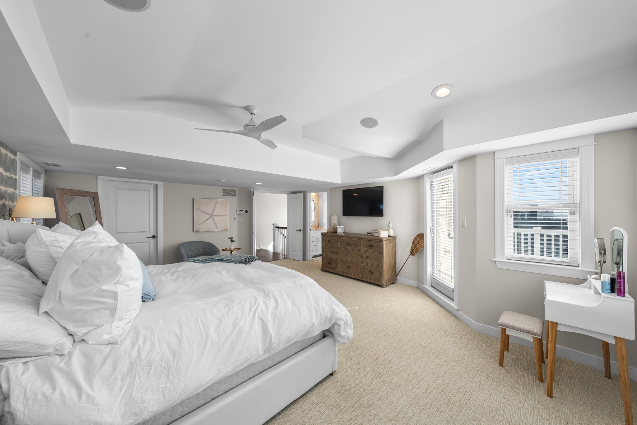 40 13th Street East Avalon, NJ 08202 - Photo 29 of 40 a spacious bedroom with a bed a couch and a flat screen tv