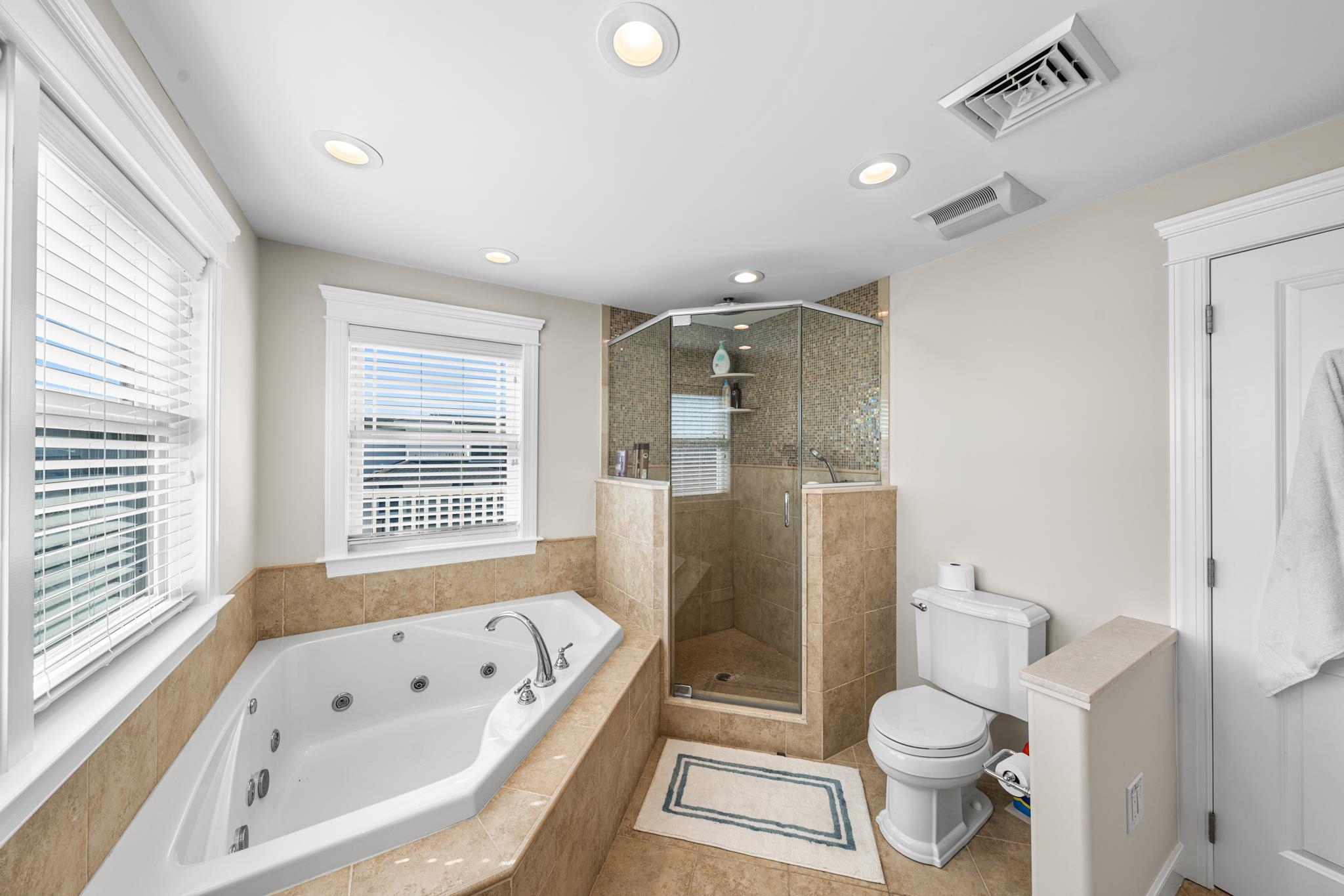 40 13th Street East Avalon, NJ 08202 - Photo 30 of 40 a bathroom with a toilet a sink a bathtub a window and a shower