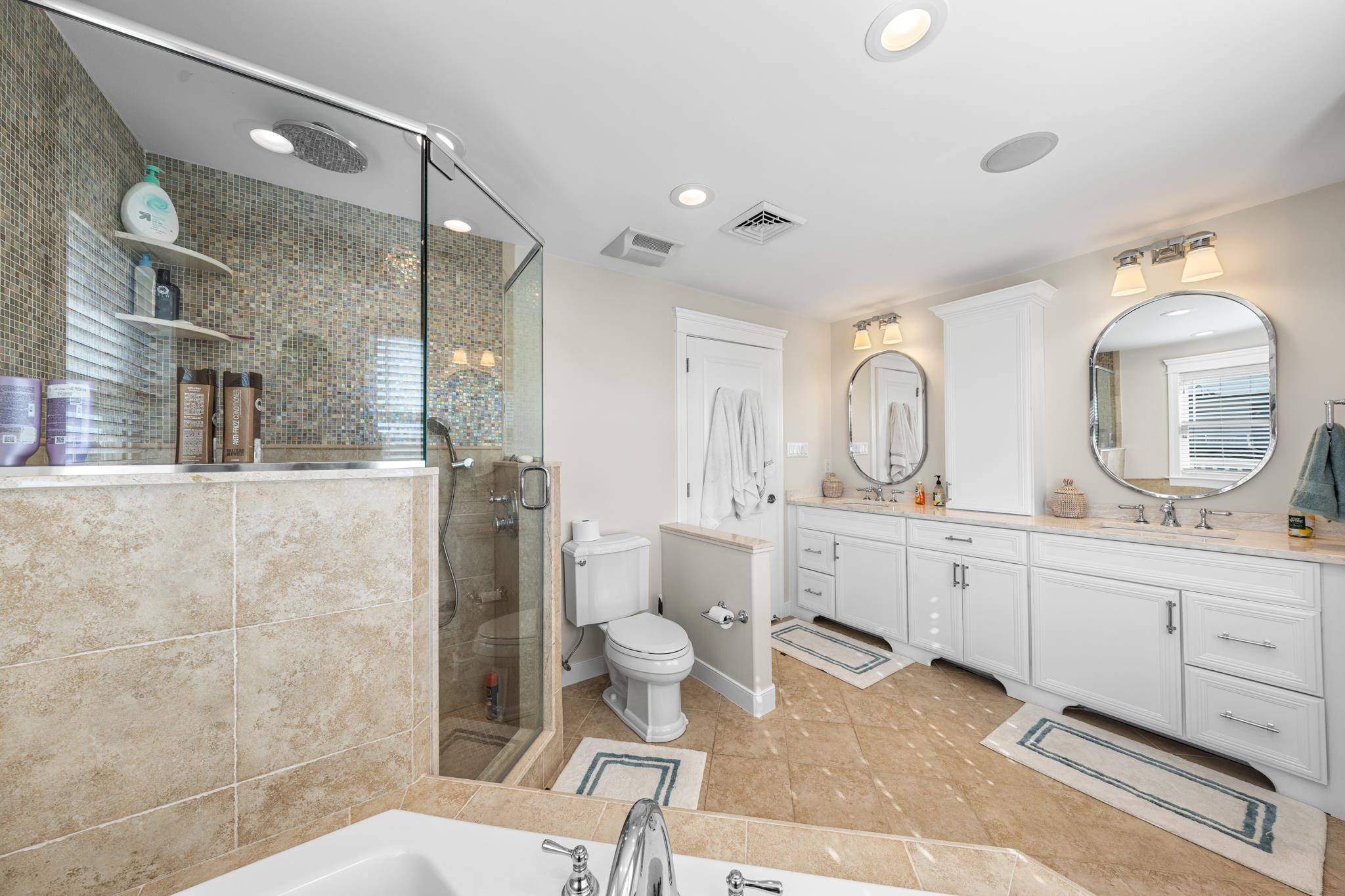 40 13th Street East Avalon, NJ 08202 - Photo 31 of 40 a spacious bathroom with double vanity a toilet a a mirror a shower and vanity