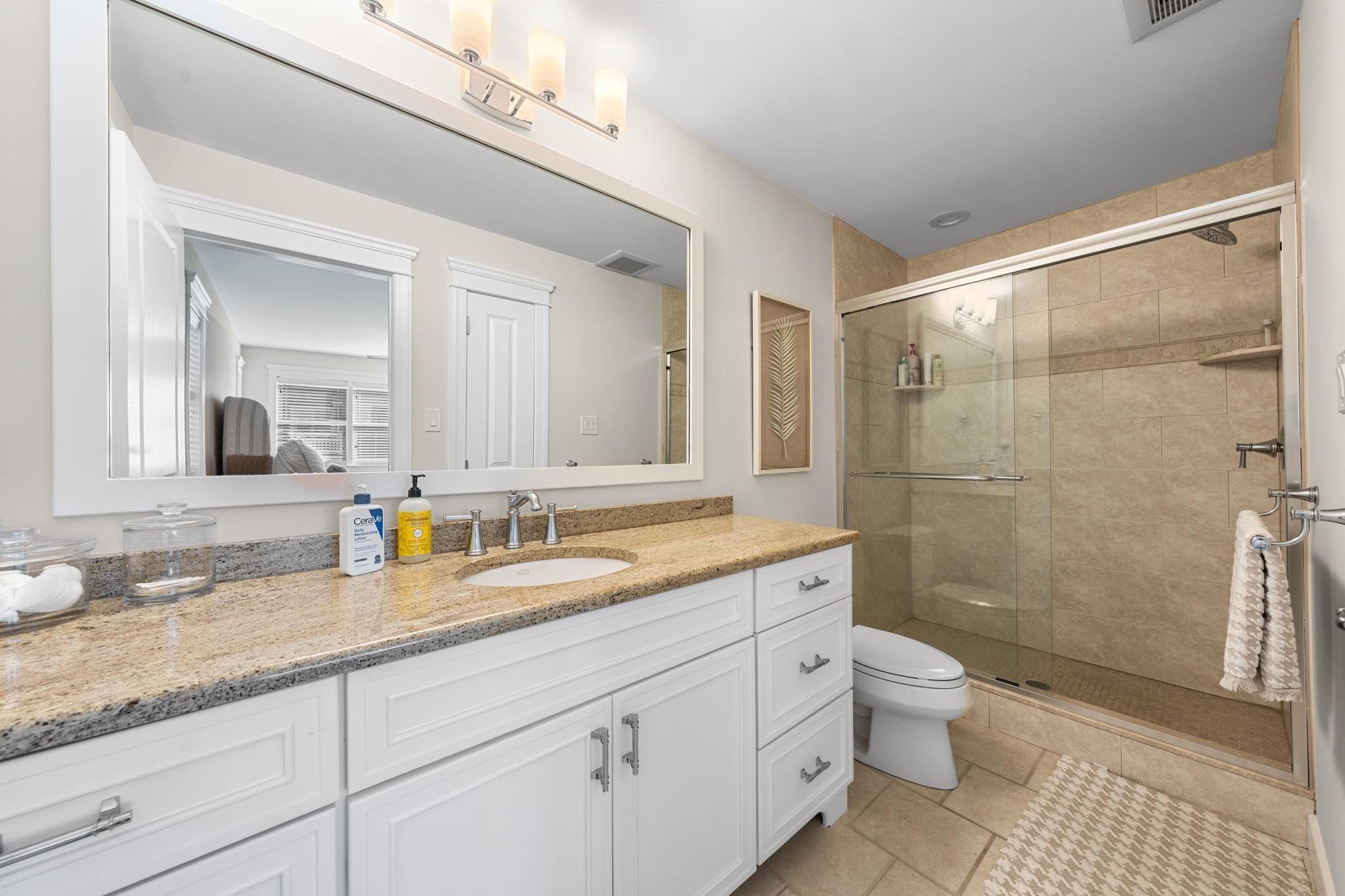 40 13th Street East Avalon, NJ 08202 - Photo 39 of 40 a bathroom with a granite countertop sink a toilet and shower