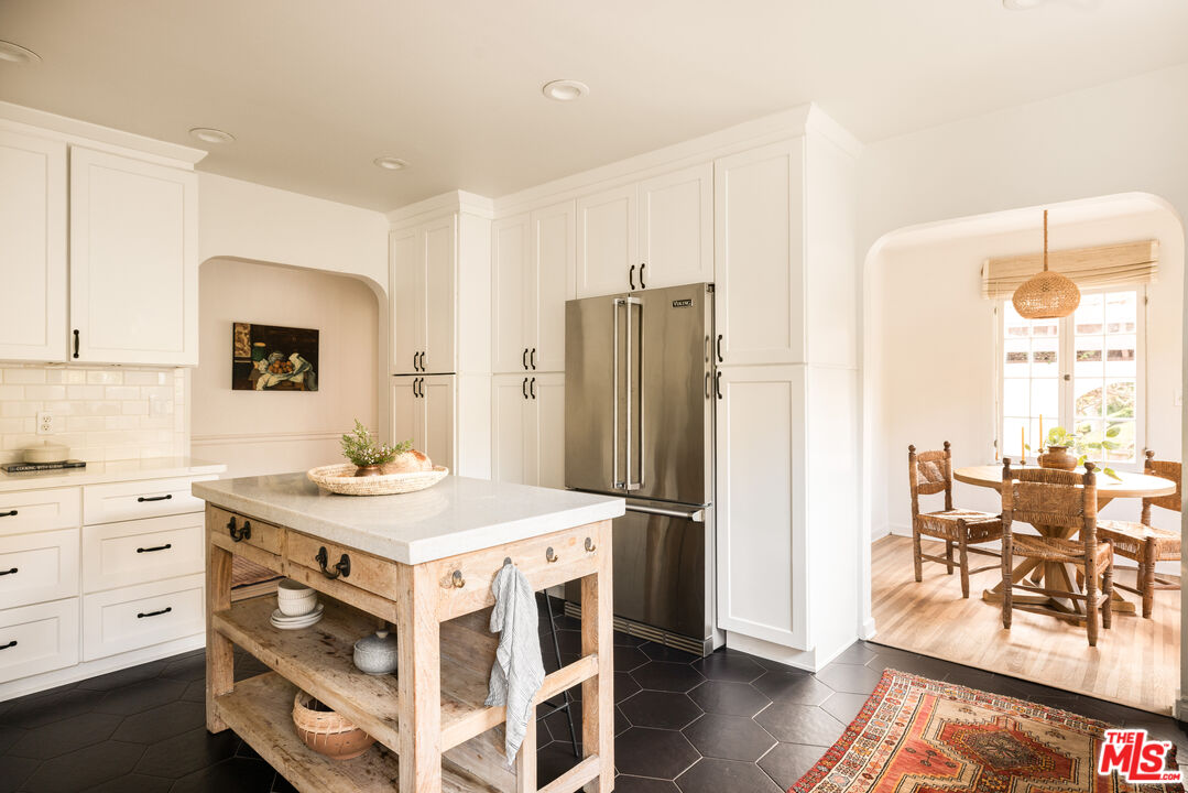 1200 Avenue 64 Pasadena, CA 91105 - Photo 16 of 62 a view of kitchen with stainless steel appliances kitchen island granite countertop a refrigerator a stove a dining table and chairs with wooden floor