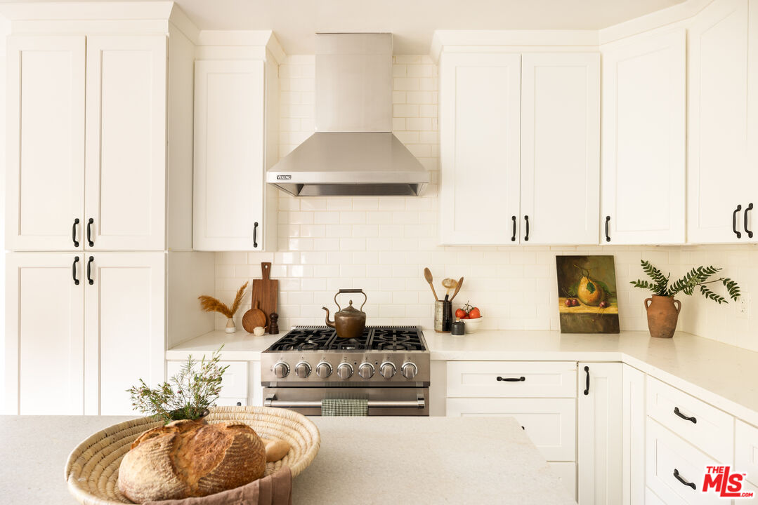 1200 Avenue 64 Pasadena, CA 91105 - Photo 20 of 62 a kitchen with a sink stove and cabinets