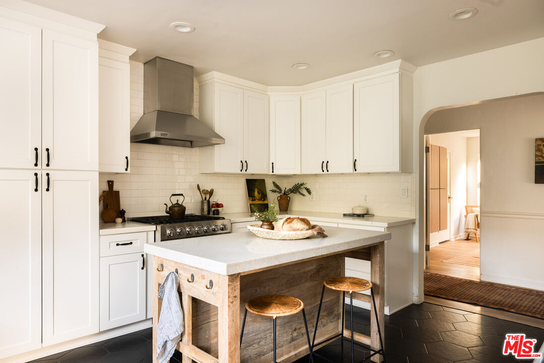 1200 Avenue 64 Pasadena, CA 91105 - Photo 21 of 62 a kitchen with stainless steel appliances a stove a table and chairs