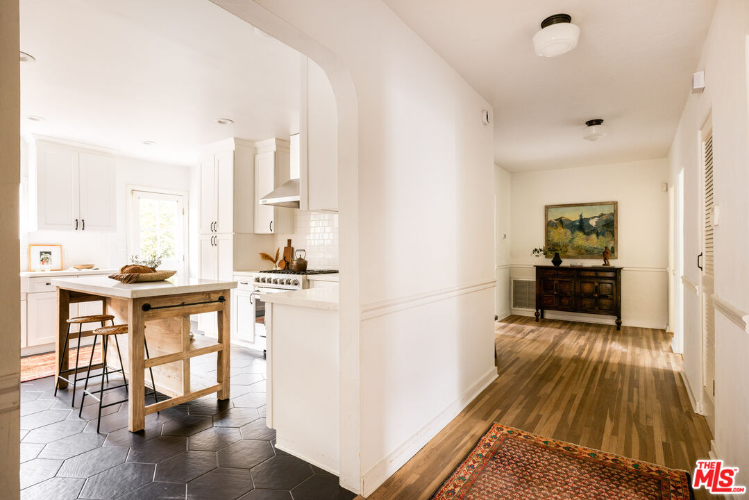 1200 Avenue 64 Pasadena, CA 91105 - Photo 22 of 62 a kitchen with wooden floor and white appliances