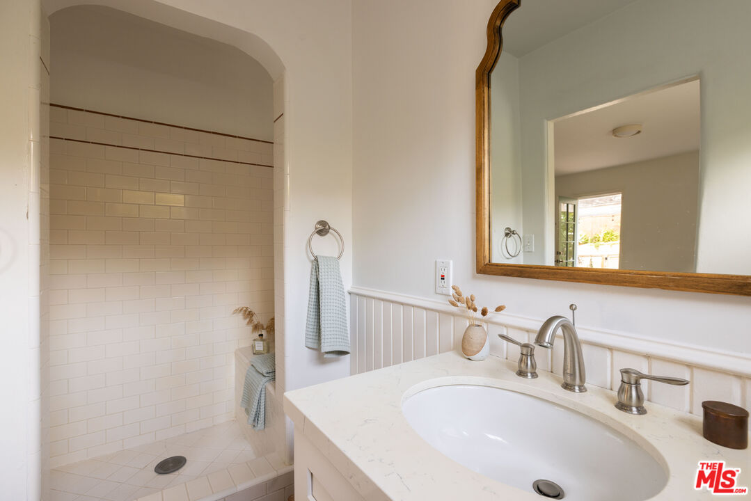 1200 Avenue 64 Pasadena, CA 91105 - Photo 33 of 62 a bathroom with a sink and a mirror
