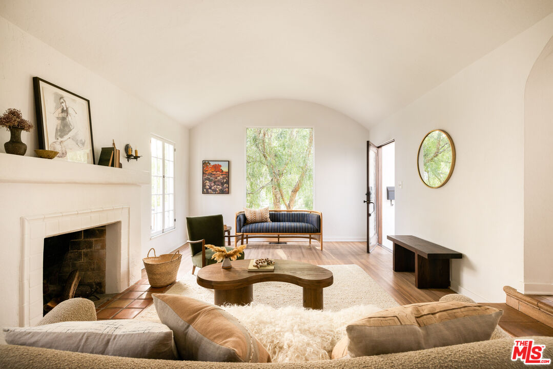 1200 Avenue 64 Pasadena, CA 91105 - Photo 8 of 62 a living room with furniture a fireplace and a large window