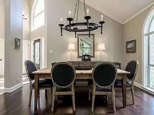 a kitchen with granite countertop a stove a sink and white cabinets with granite countertops