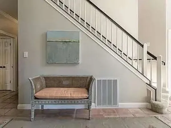 a balcony with furniture and wooden floor