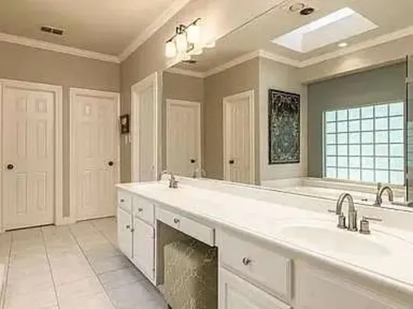 a spacious bathroom with a granite countertop sink mirror and a