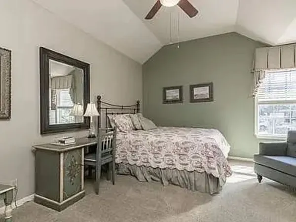 a bedroom with a bed and a window