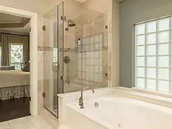 a bathroom with a tub shower and sink