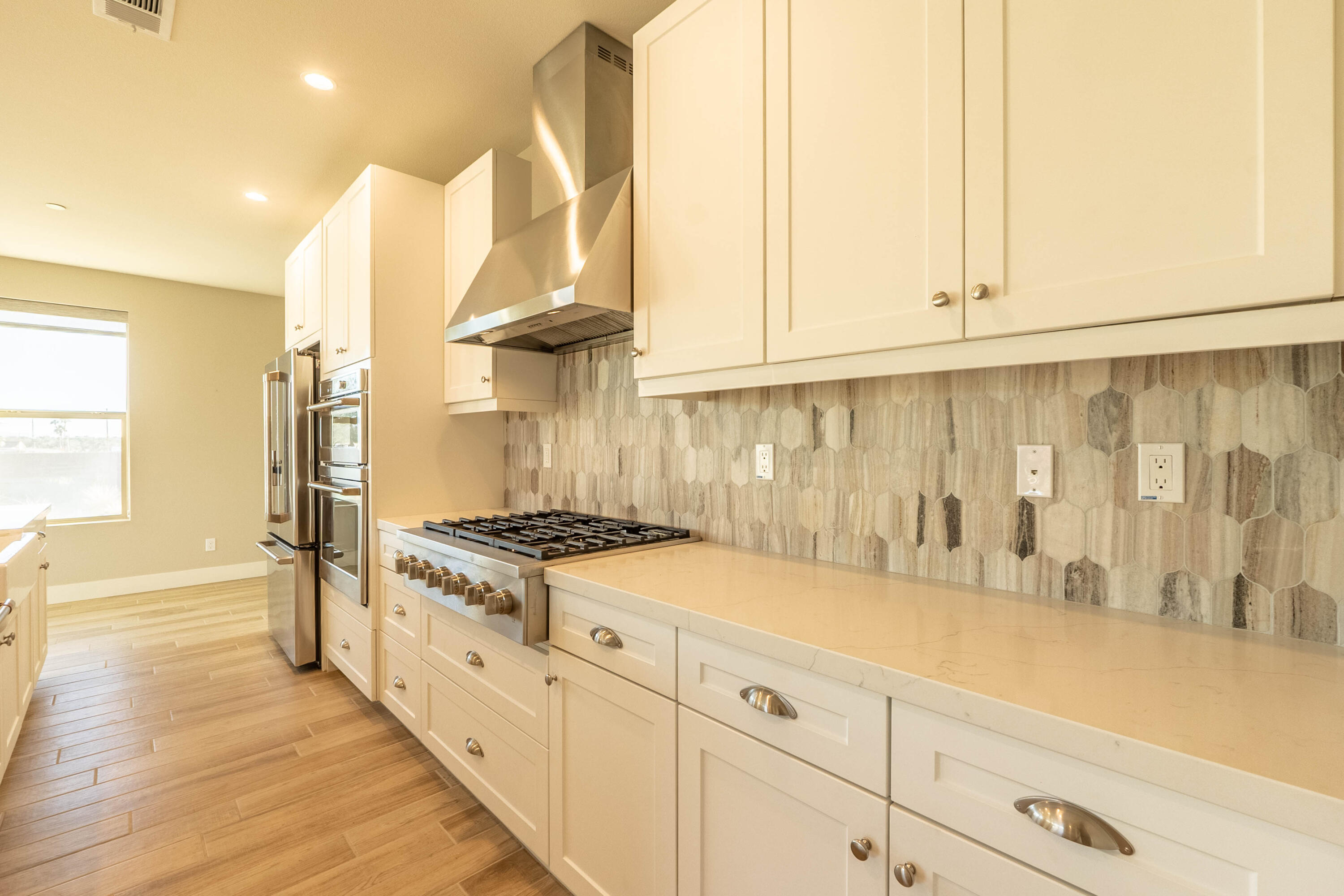 51502 Mastic Way Indio, CA 92201 - Photo 11 of 29 a kitchen with granite countertop a stove and a white cabinets