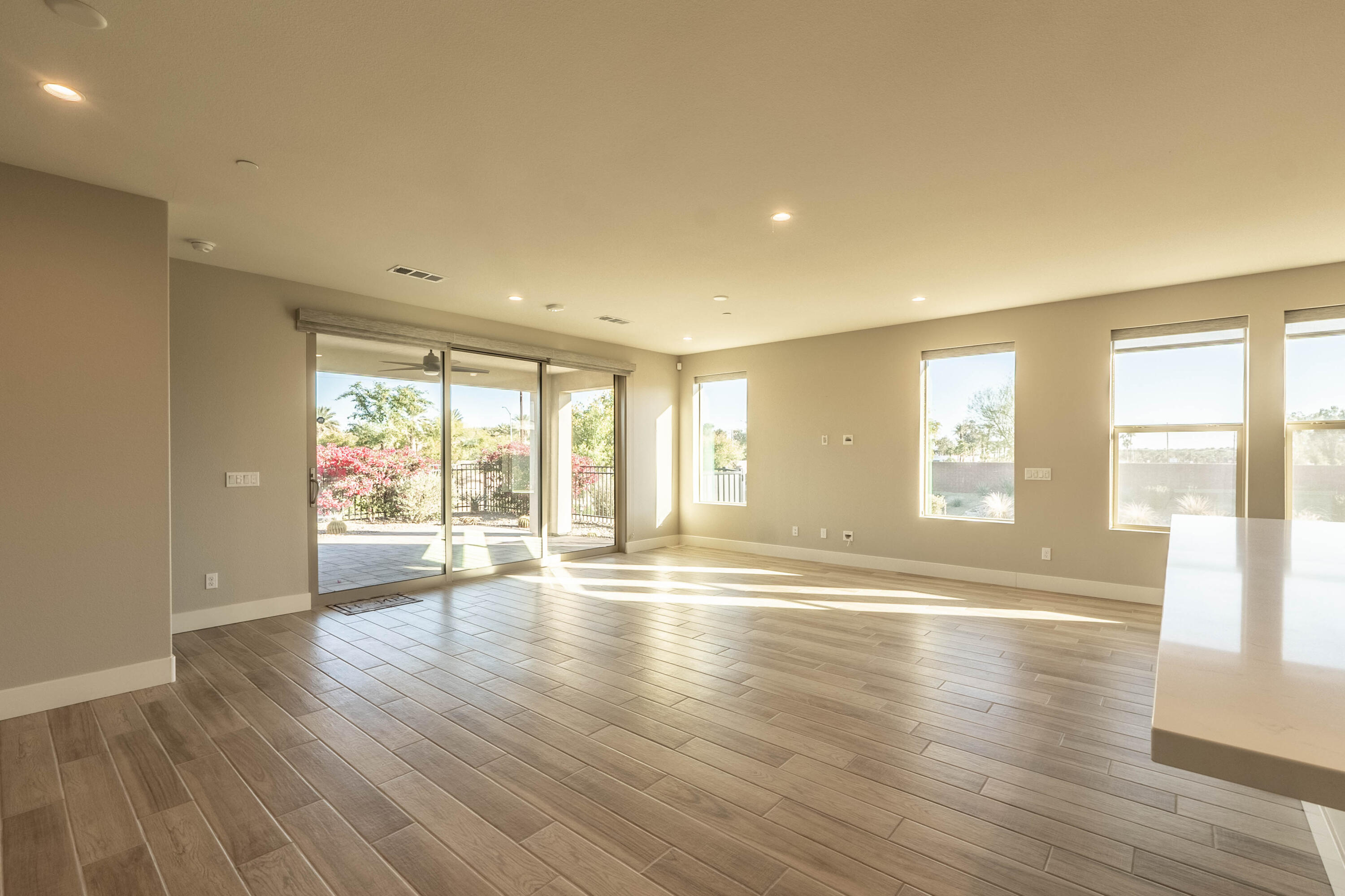 51502 Mastic Way Indio, CA 92201 - Photo 2 of 29 a view of an empty room with wooden floor and a window