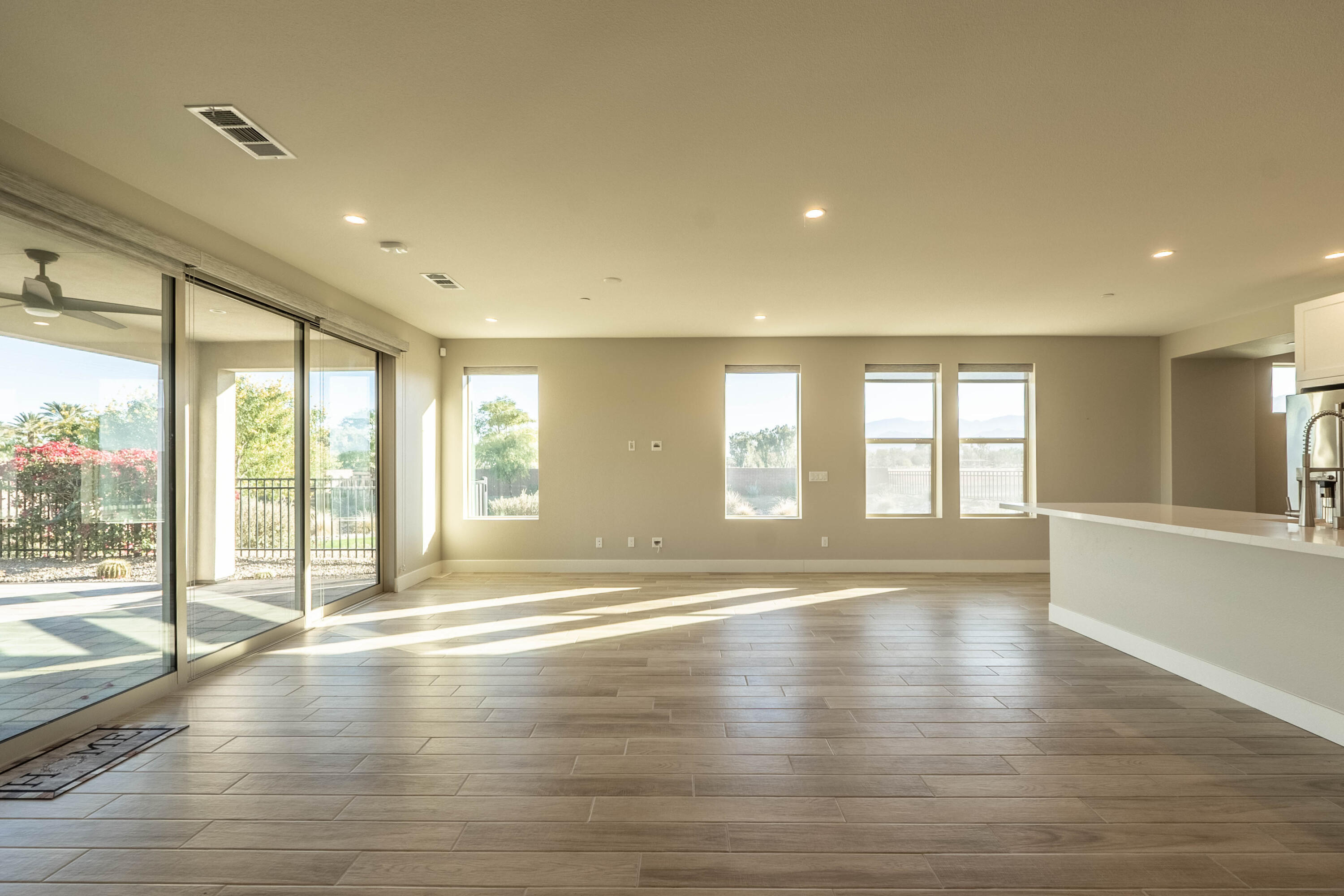 51502 Mastic Way Indio, CA 92201 - Photo 4 of 29 a view of an empty room with wooden floor and a window