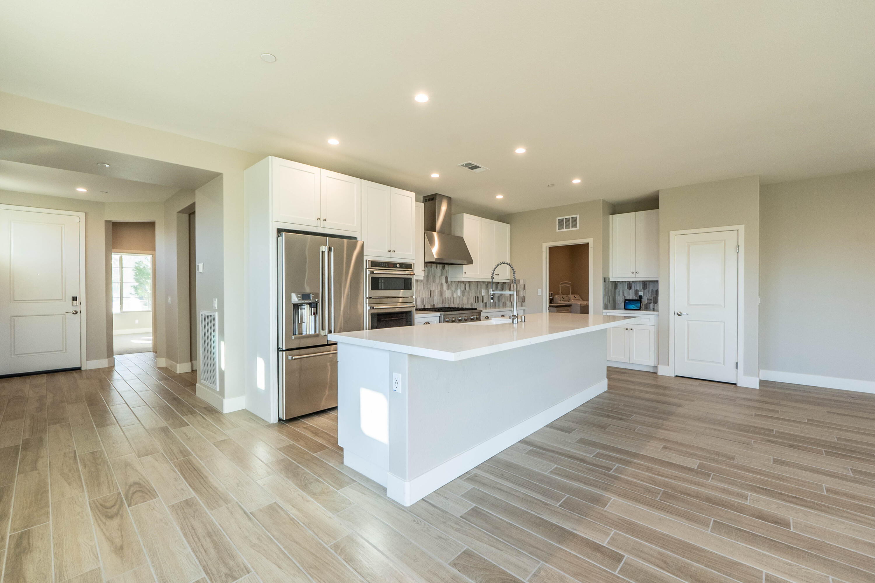 51502 Mastic Way Indio, CA 92201 - Photo 8 of 29 a large kitchen with stainless steel appliances a large counter top and a stove