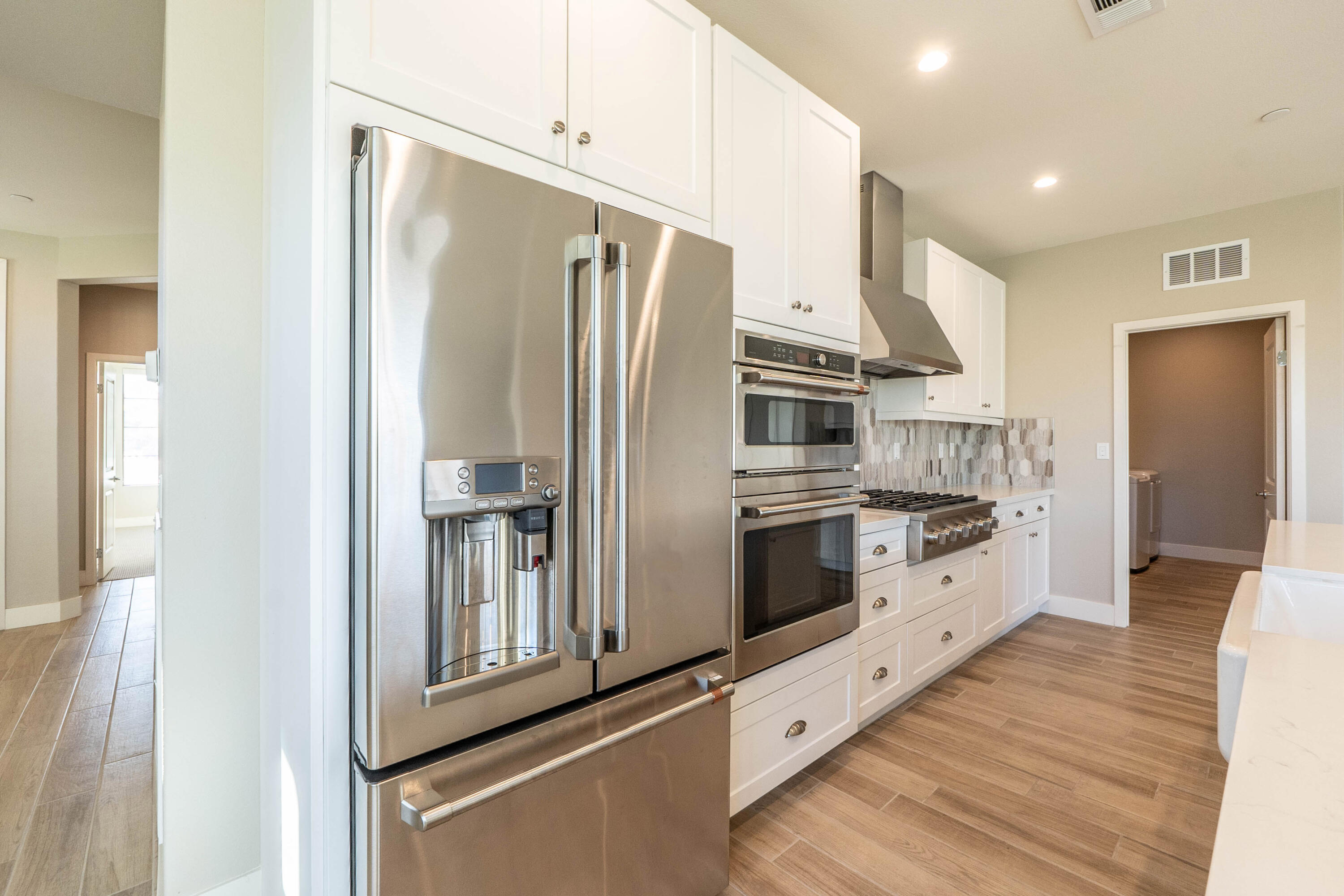 51502 Mastic Way Indio, CA 92201 - Photo 10 of 29 a kitchen with stainless steel appliances a refrigerator sink and cabinets