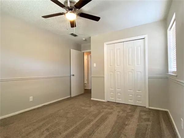 a view of an empty room and a window