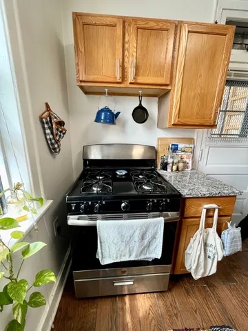 a stove top oven sitting inside of a kitchen