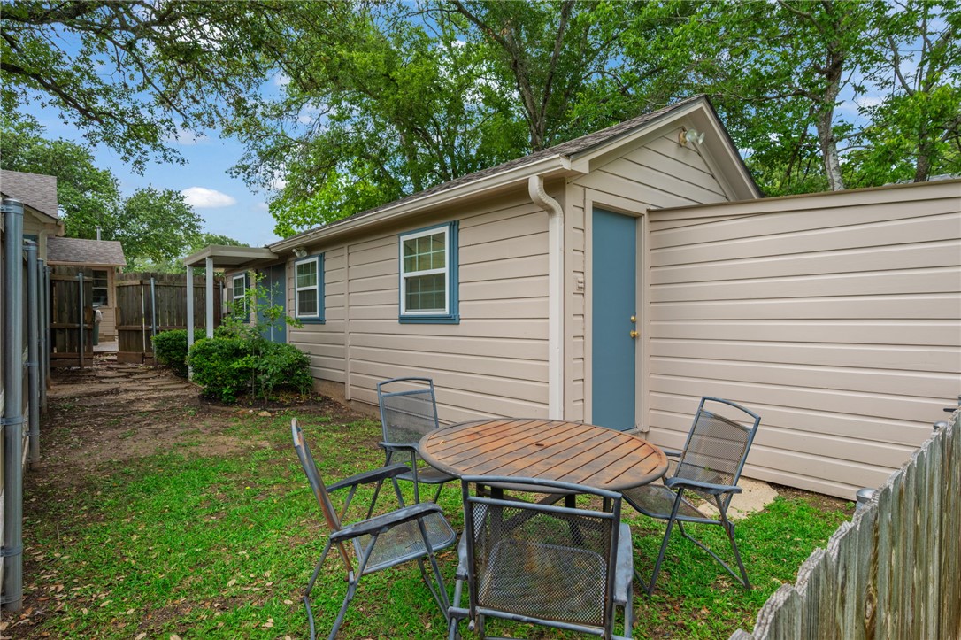 715 Inwood Drive Bryan, TX 77802 - Photo 13 of 34 a backyard of a house with table and chairs
