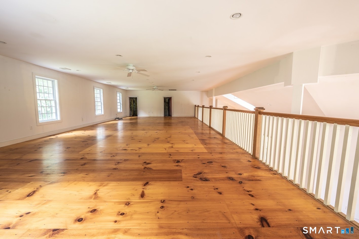 19 High Street Middlefield, CT 06455 - Photo 12 of 18 Expansive second-floor loft overlooking the soaring great room provides exceptional flexible space for a home office, media room, fitness area, studio, or additional living space.