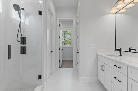 a bathroom with a double vanity sink a and a shower