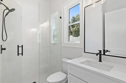 a bathroom with a sink toilet and shower