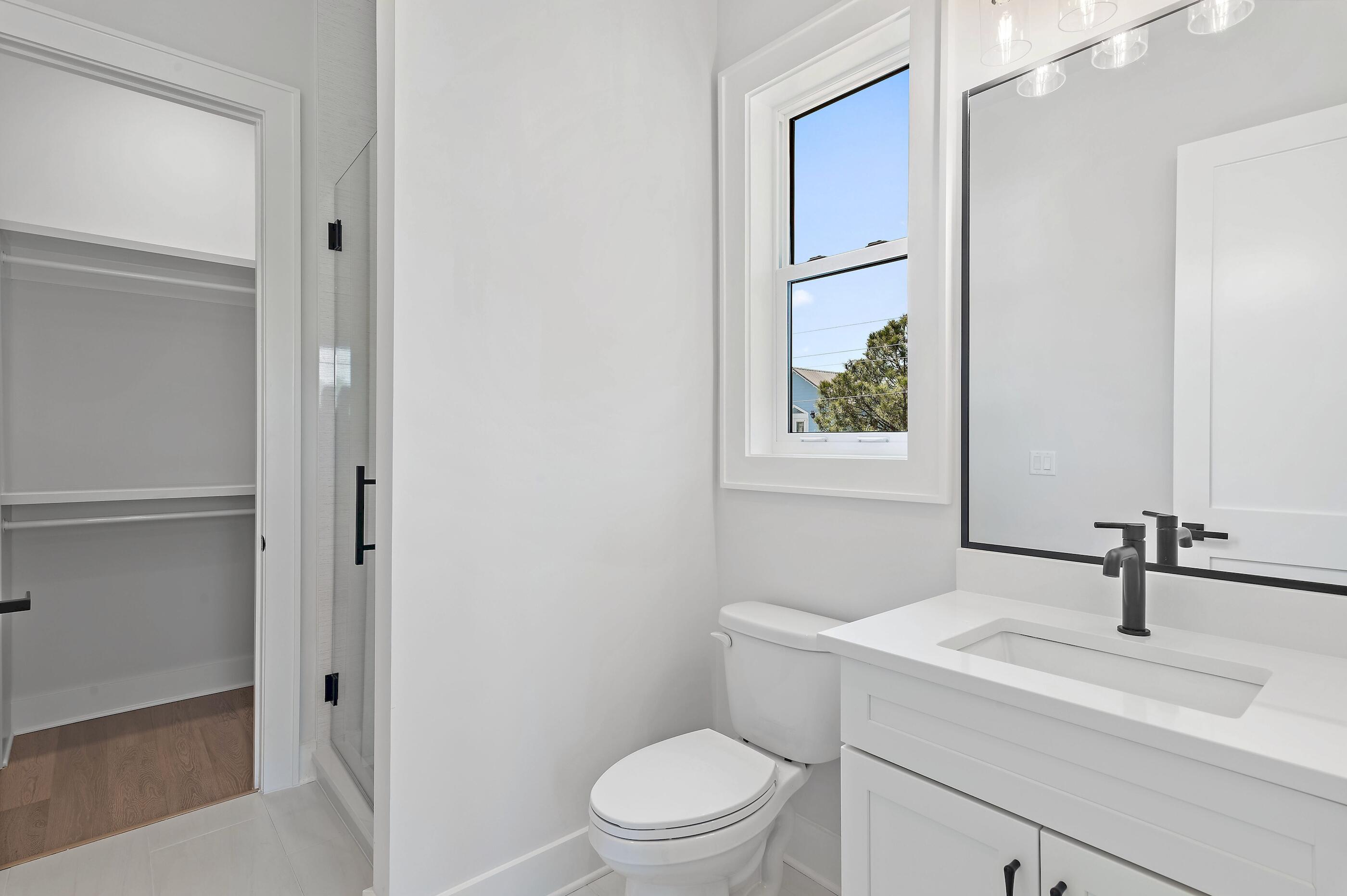 22 Henderson Place Santa Rosa Beach, FL 32459 - Photo 21 of 33 a bathroom with a toilet a sink a mirror and vanity