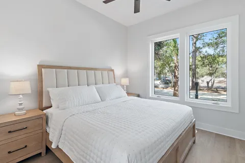 a bedroom with a large bed and a window