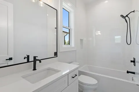 a bathroom with a sink a toilet and a tub