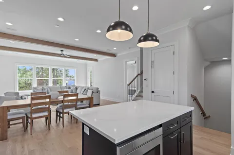 a very nice looking dining room with a large window and chandelier