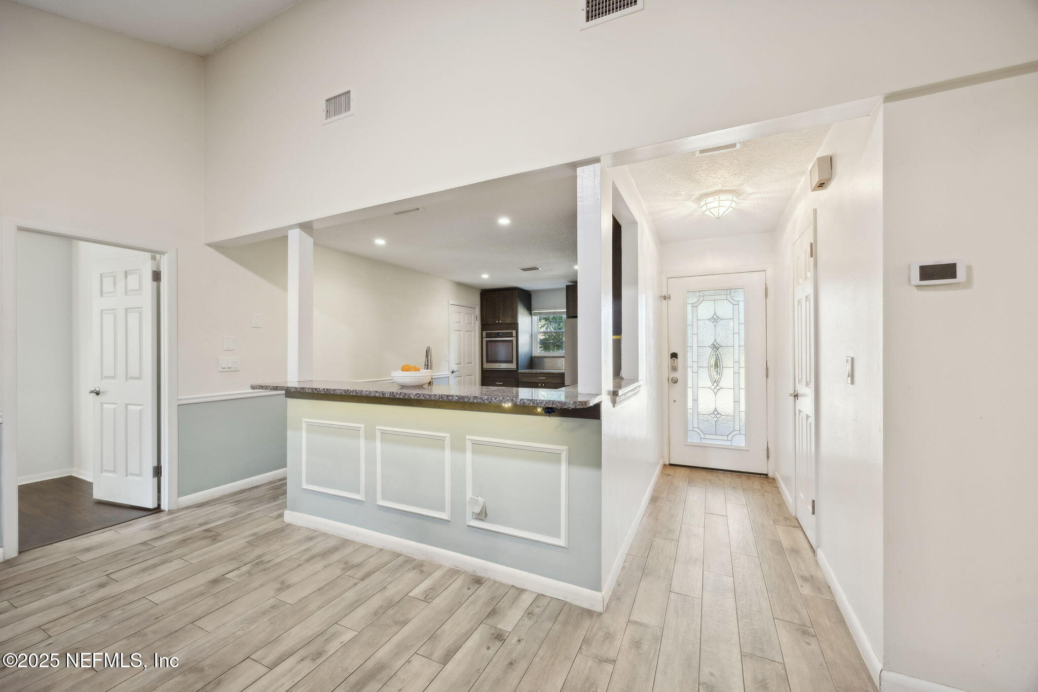225 San Pablo Road North Jacksonville, FL 32225 - Photo 6 of 38 a large kitchen with cabinets wooden floor and stainless steel appliances