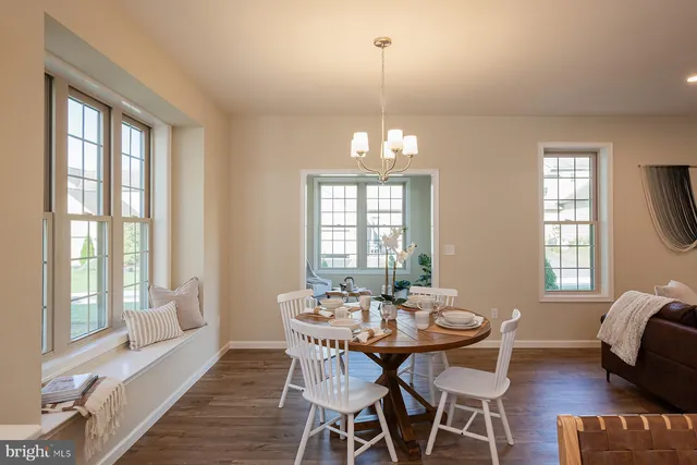 a view of a dining room with furniture windows and wooden floor