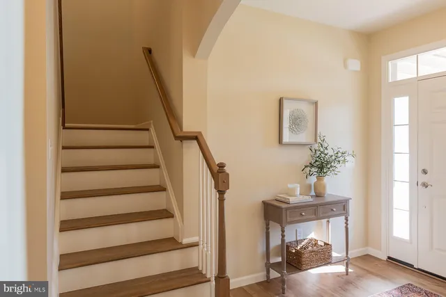 a view of entryway and hall with wooden floor