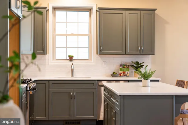 a kitchen with a sink cabinets and a window