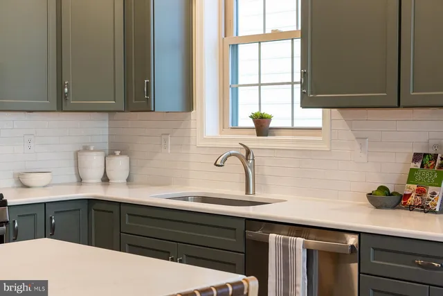 a kitchen with stainless steel appliances a sink dishwasher window and cabinets