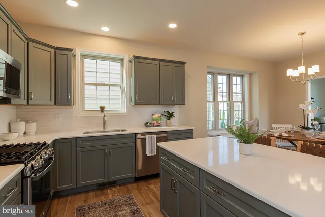 a kitchen with a sink stove and cabinets