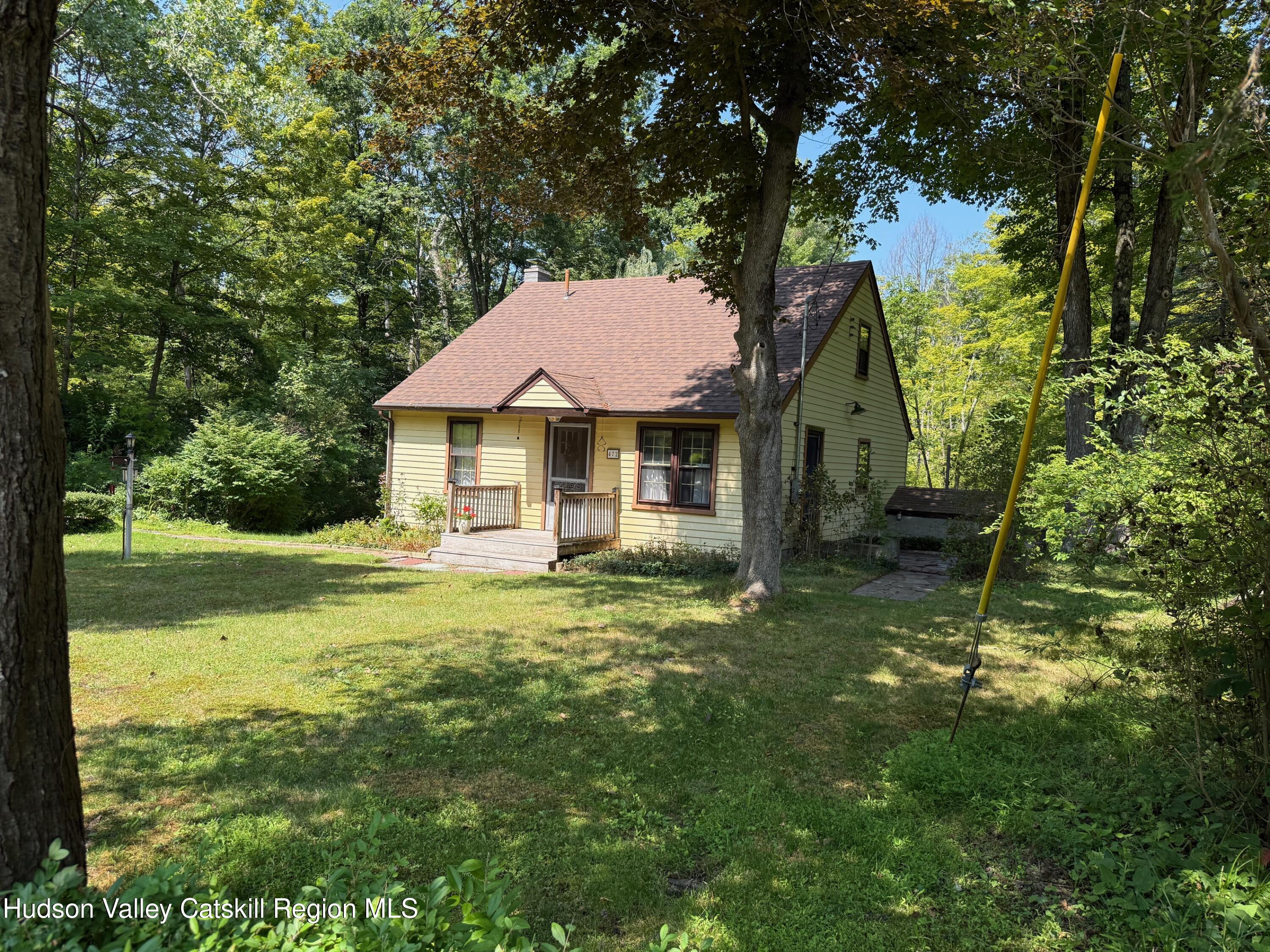 a view of a house with a yard and sitting area