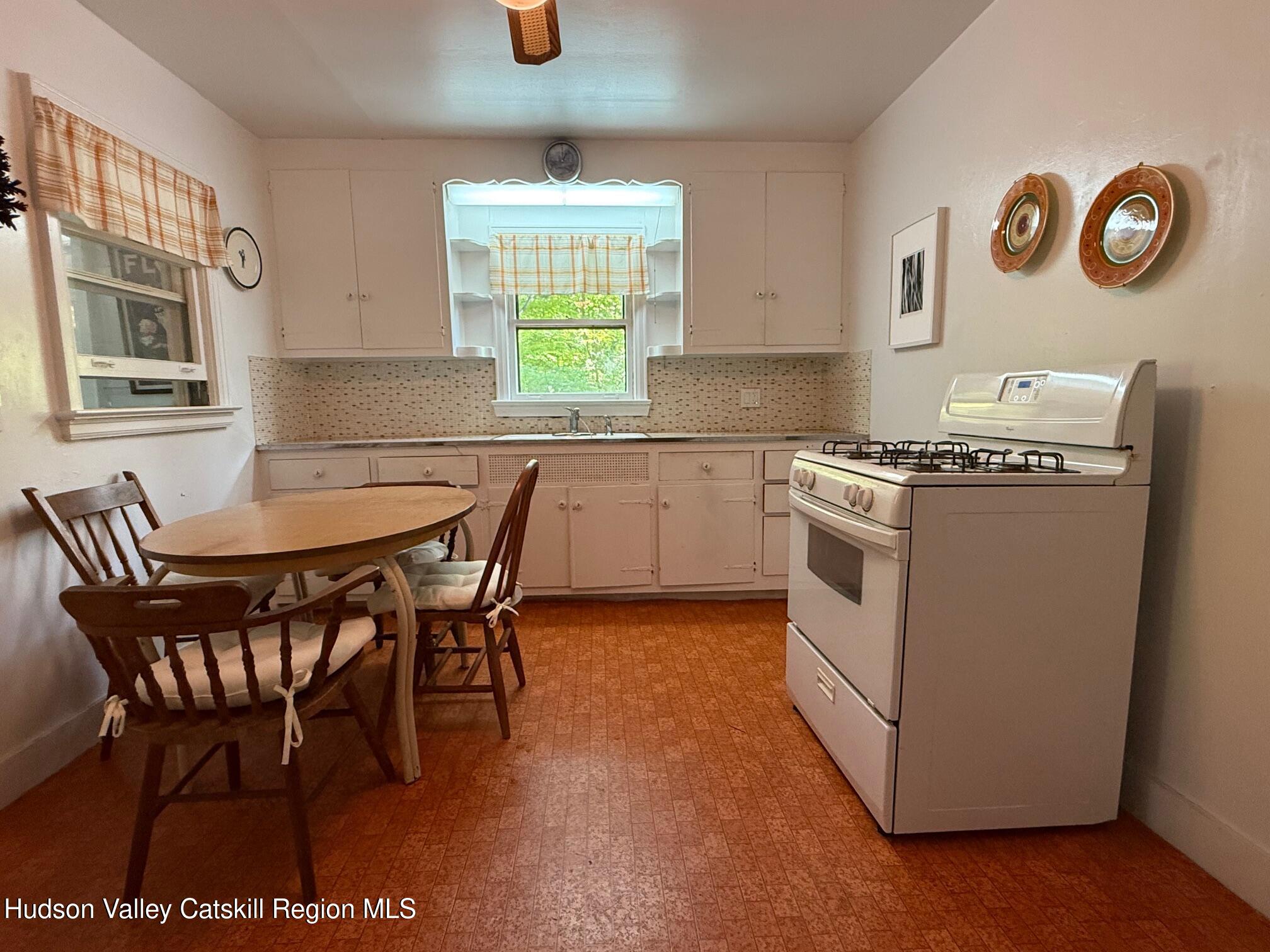 472 Doodletown Road Ancram, NY 12502 - Photo 8 of 23 a kitchen with a stove a table and chairs
