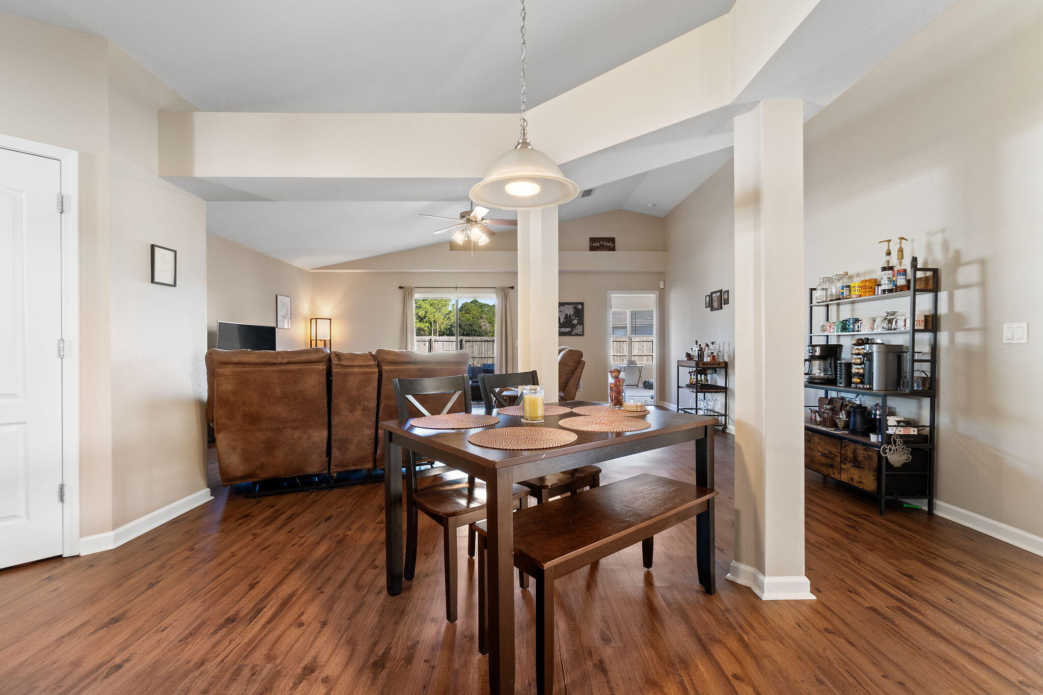 7964 Promise Creek Road Navarre, FL 32566 - Photo 11 of 43 a view of a dining room with furniture and wooden floor