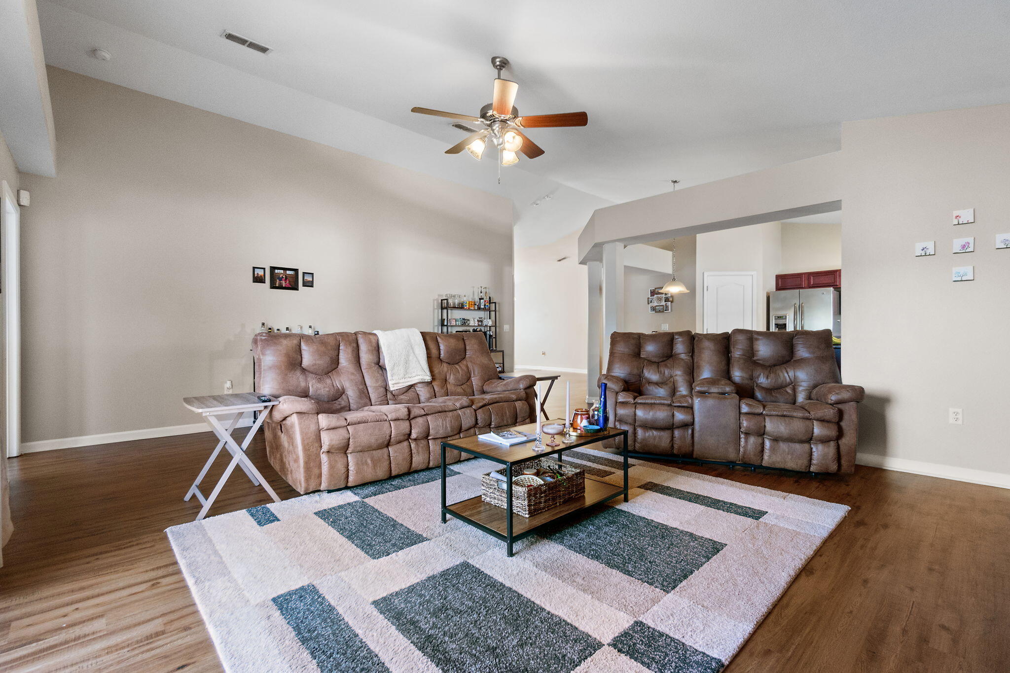 7964 Promise Creek Road Navarre, FL 32566 - Photo 15 of 43 a living room with furniture and wooden floor