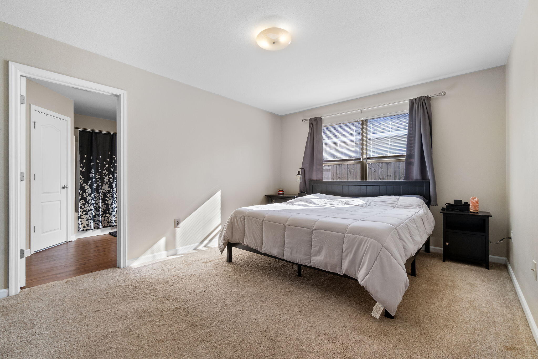 7964 Promise Creek Road Navarre, FL 32566 - Photo 23 of 43 a spacious bedroom with a bed and a window