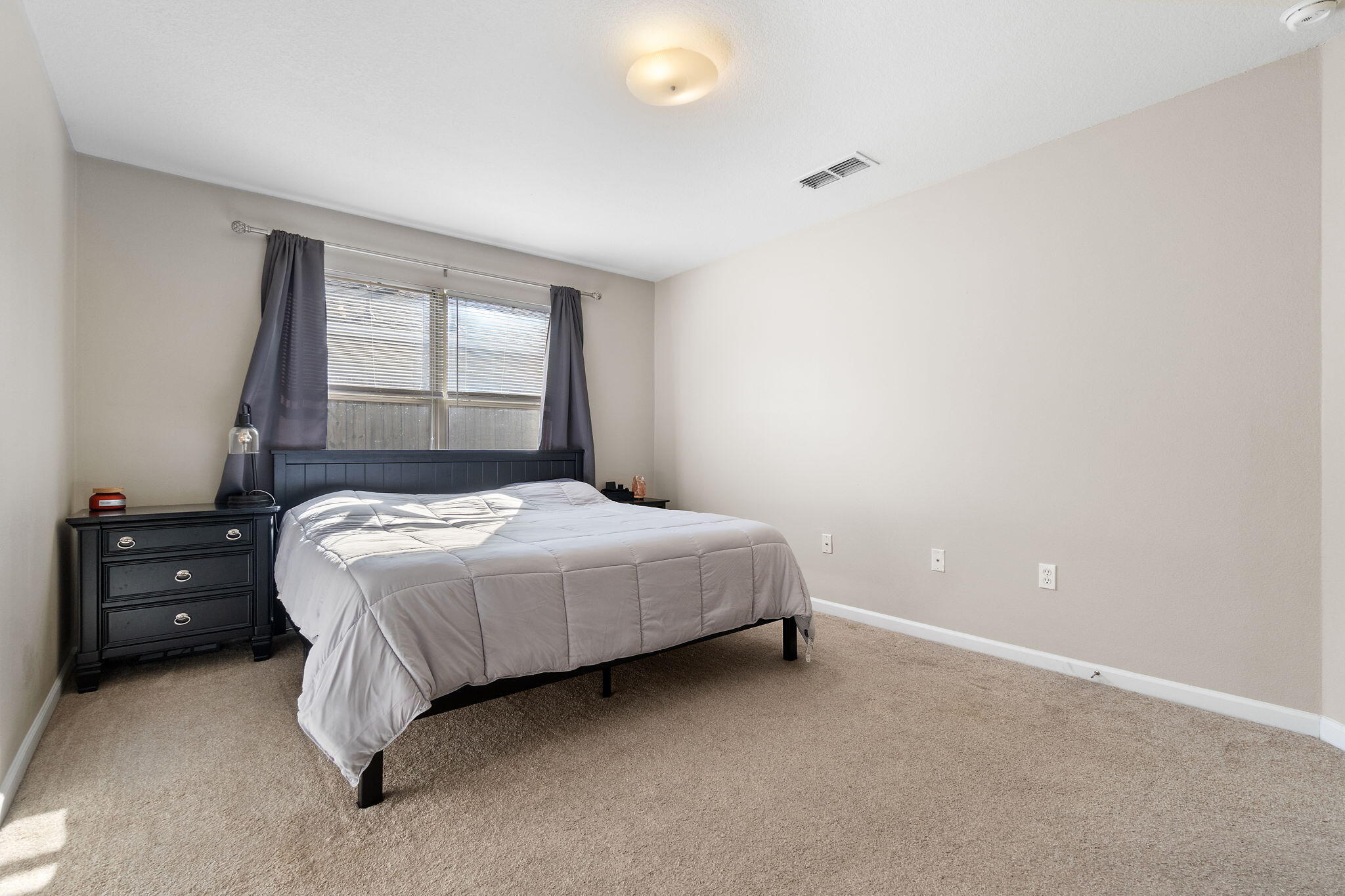 7964 Promise Creek Road Navarre, FL 32566 - Photo 26 of 43 a bedroom with a bed and a window