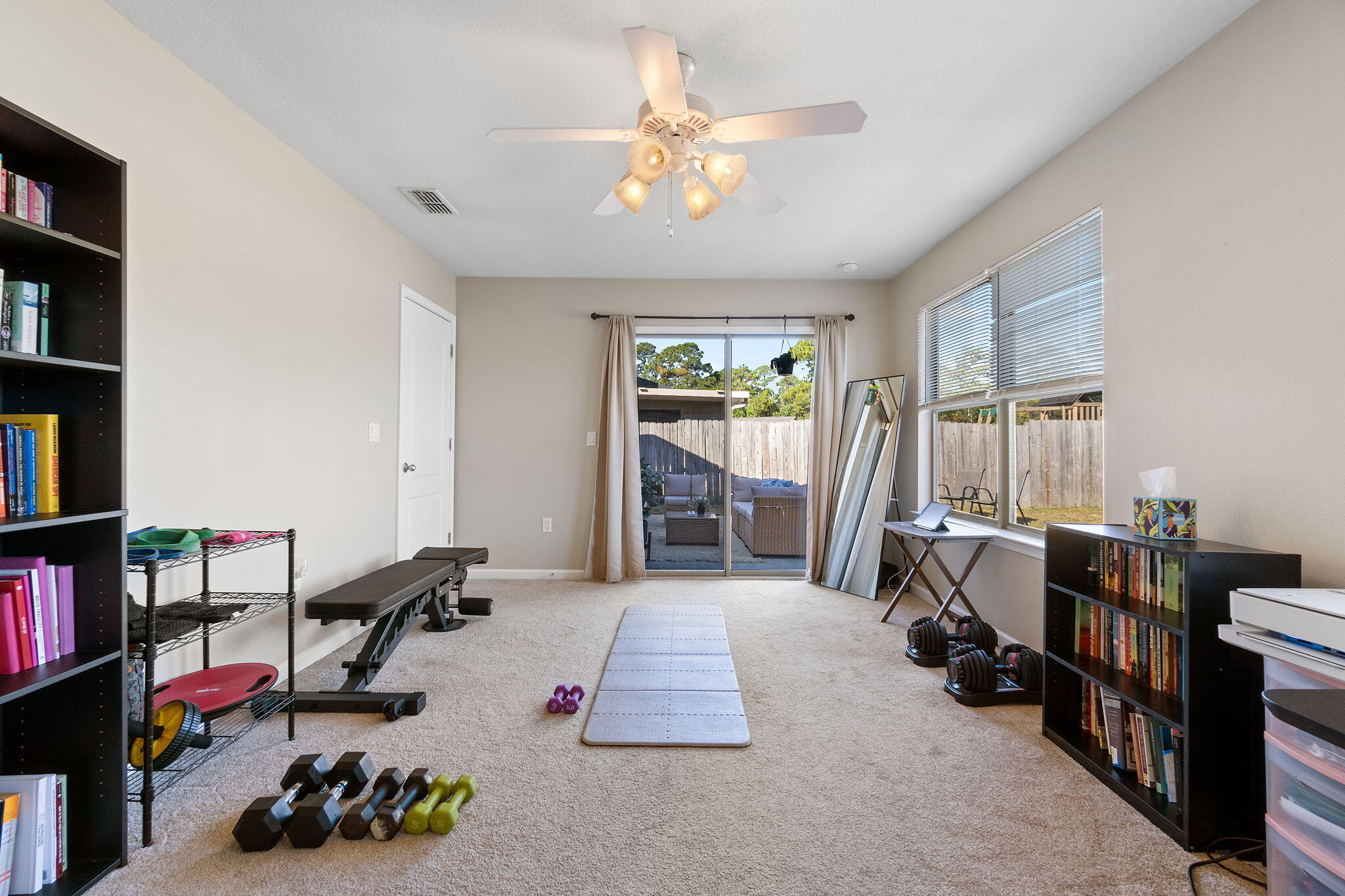 7964 Promise Creek Road Navarre, FL 32566 - Photo 32 of 43 a room with lots of furniture and a book shelf