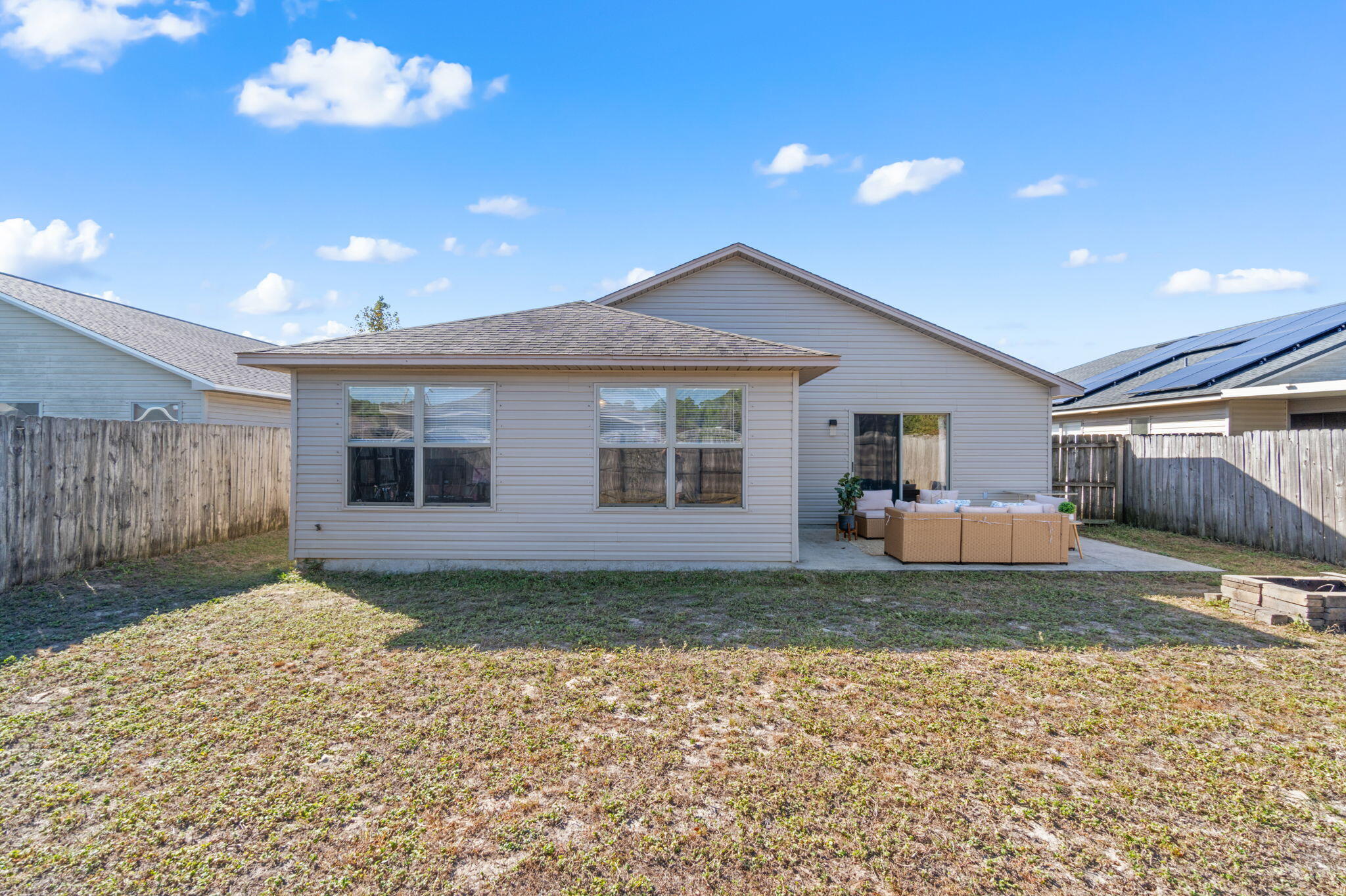 7964 Promise Creek Road Navarre, FL 32566 - Photo 37 of 43 a view of a house with a patio and a yard