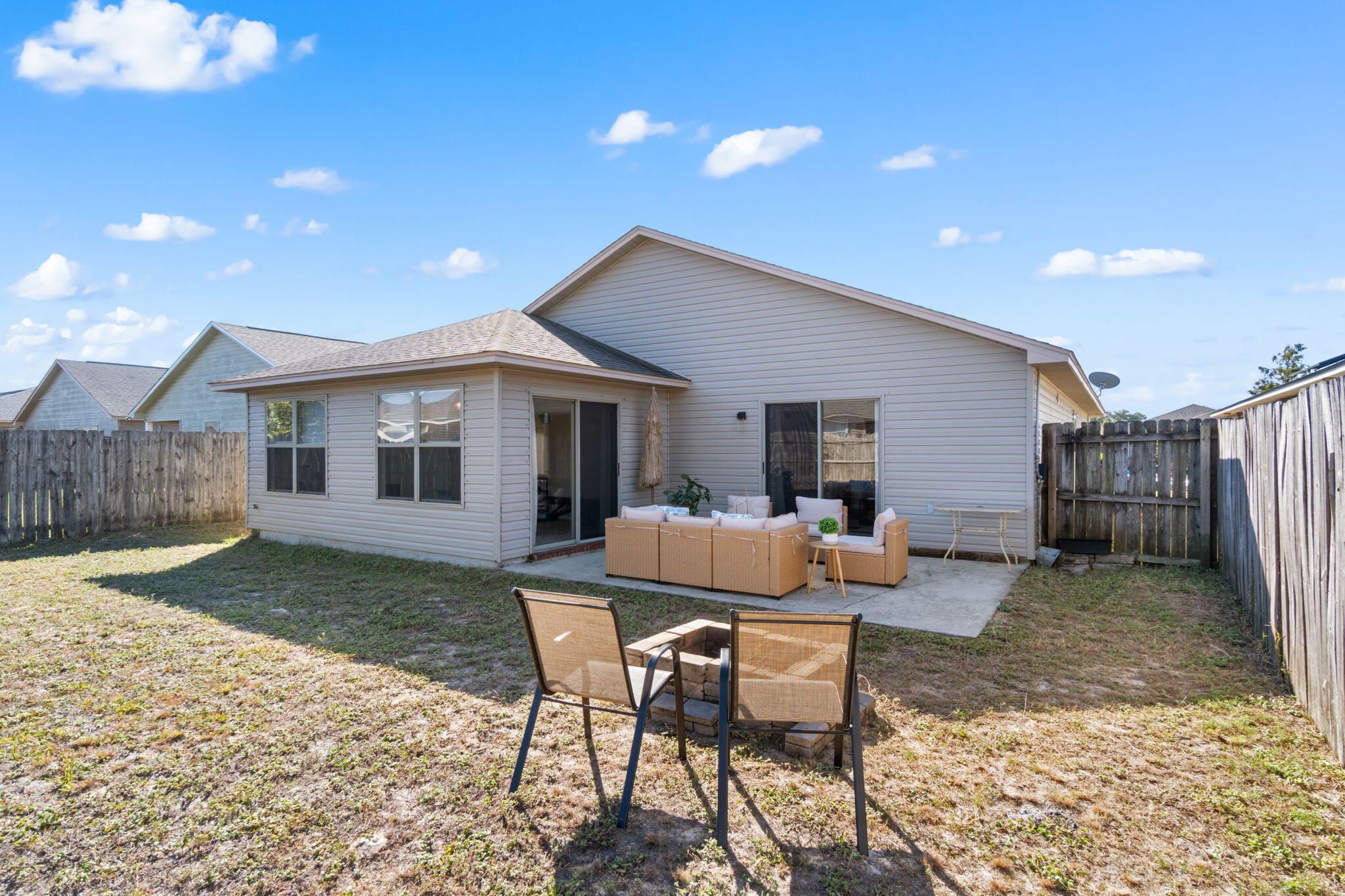 7964 Promise Creek Road Navarre, FL 32566 - Photo 38 of 43 a backyard of a house with seating space