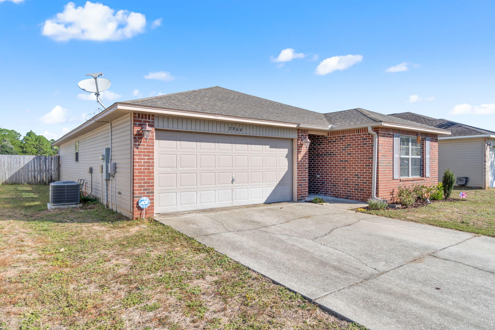 7964 Promise Creek Road Navarre, FL 32566 - Photo 42 of 43 a front view of a house with a yard and garage