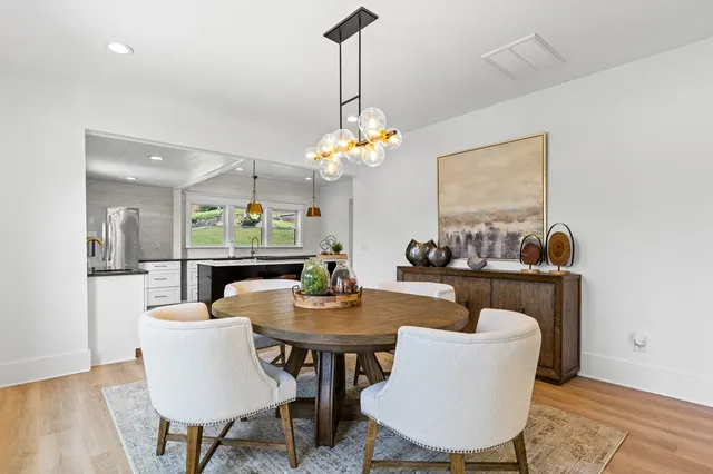 a dining room with furniture a rug and wooden floor